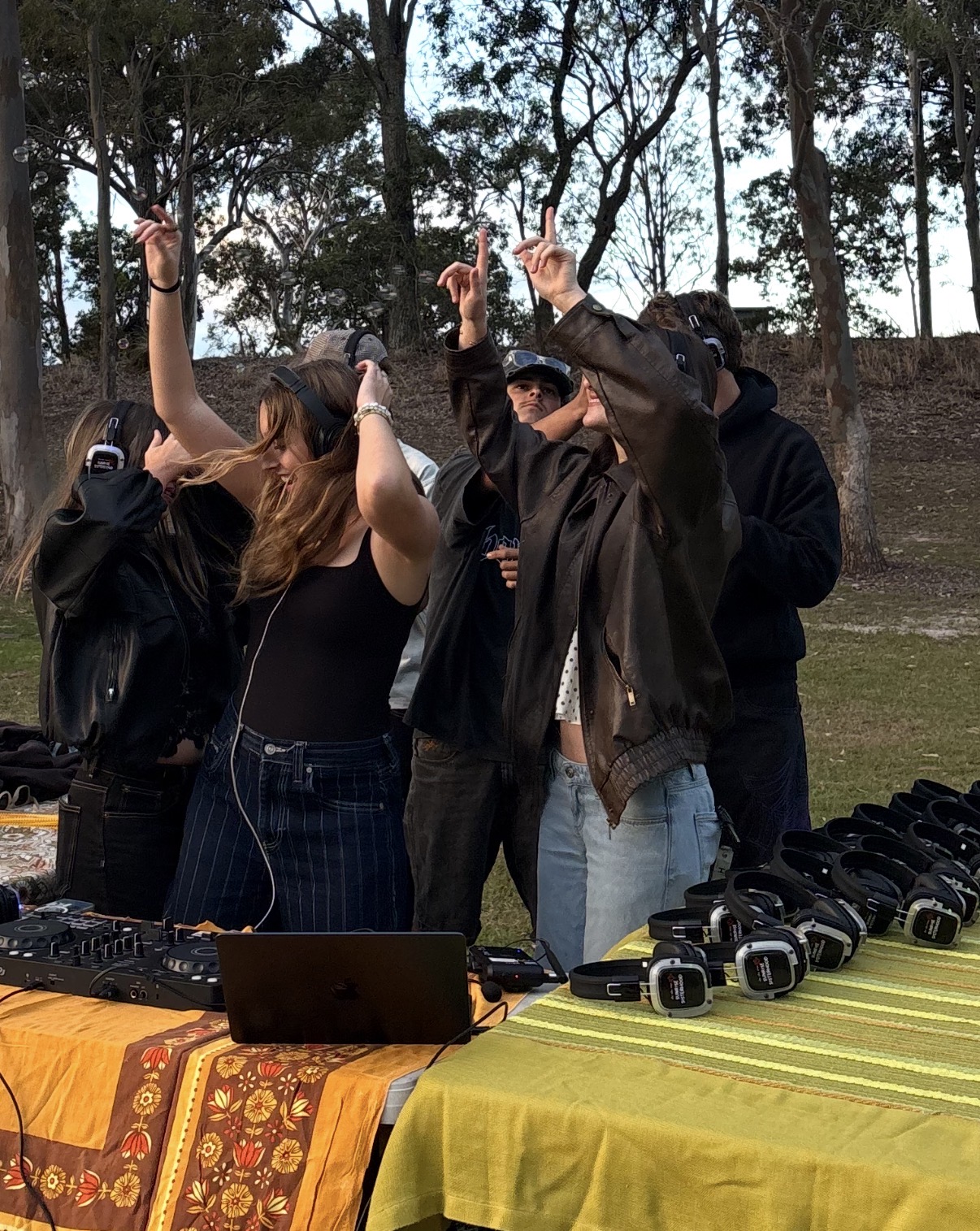EDN DJ setting up a table of silent disco headphones at a Moreton Bay pop-up