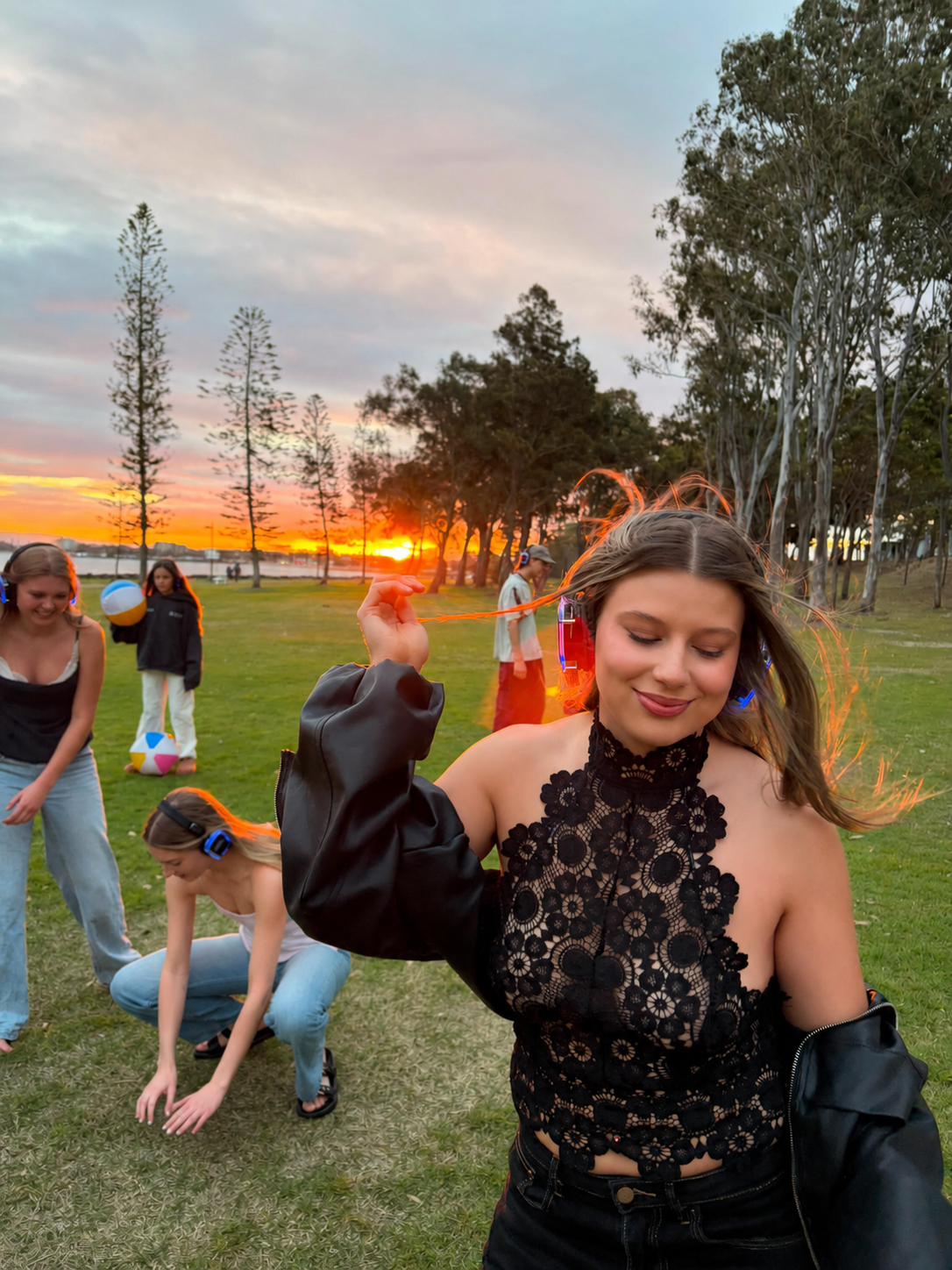 A dancer in glowing headphones at golden hour at a Silent Sets pop-up rave